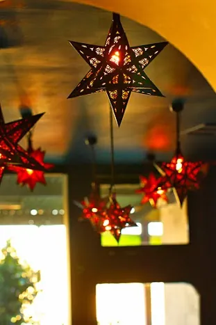 Pierced metal star lanterns glowing red