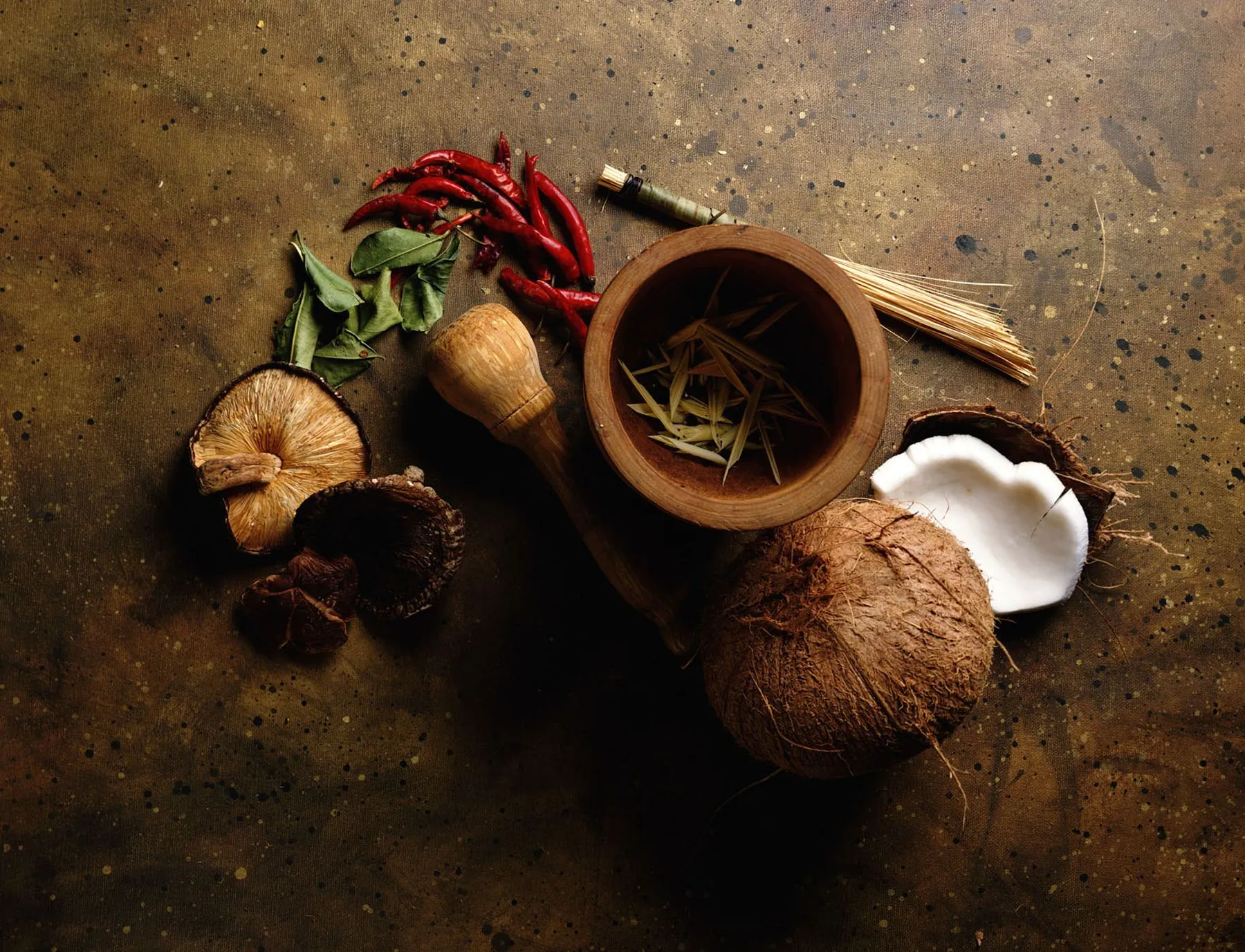 Whole spices, dried chilli and coconut on a dark board