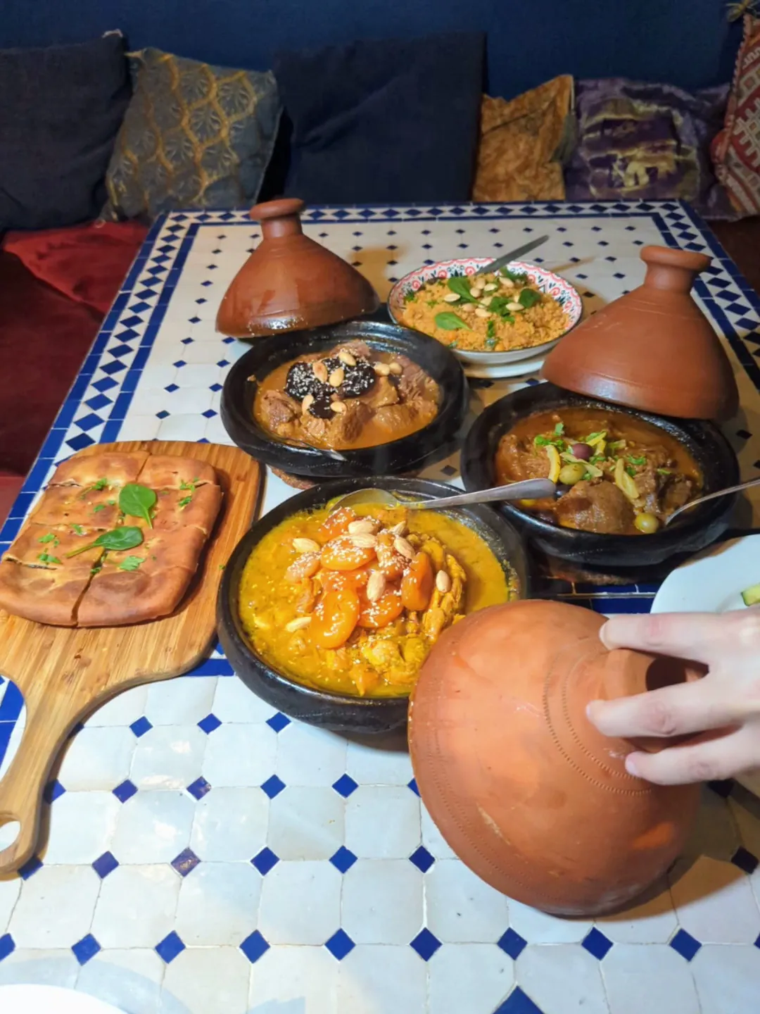 A table of tagines, bread and dips at Marrakech